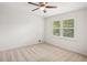 Bright bedroom with neutral carpet, ceiling fan and shuttered windows for natural light, showing comfort at 3013 Huntshire, Doraville, GA 30340