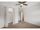 Bedroom boasts carpet, a ceiling fan, and a closet with louvered doors, alongside an adjacent room at 3013 Huntshire, Doraville, GA 30340