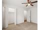 Bedroom with neutral carpet, ceiling fan, a closet with louvered doors, and an entrance to another room at 3013 Huntshire, Doraville, GA 30340