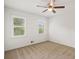 Bedroom featuring carpeted flooring, two large windows, and neutral walls complemented with a ceiling fan at 3013 Huntshire, Doraville, GA 30340