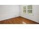 Bedroom with hardwood floors, white wainscoting and trim, and shuttered windows at 3013 Huntshire, Doraville, GA 30340