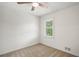 Bright bedroom features neutral carpet, a ceiling fan, and natural light from the window at 3013 Huntshire, Doraville, GA 30340