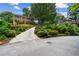 Long driveway leading to a traditional brick home surrounded by lush greenery at 3013 Huntshire, Doraville, GA 30340