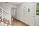 Bright foyer with staircase, tile flooring and white door leading outside at 3013 Huntshire, Doraville, GA 30340