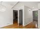 Hallway with hardwood floors and white wainscoting leads into a living room and a staircase at 3013 Huntshire, Doraville, GA 30340
