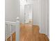 Upstairs hallway with wood flooring and white trim on the stairs and doors, leading to other rooms at 3013 Huntshire, Doraville, GA 30340