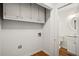 Laundry room featuring upper cabinets and a view into a half bath at 3013 Huntshire, Doraville, GA 30340