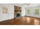 Bright living room featuring a brick fireplace, hardwood floors, and large windows at 3013 Huntshire, Doraville, GA 30340
