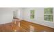 Bright living room featuring hardwood floors, white walls, and large windows at 3013 Huntshire, Doraville, GA 30340