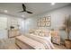 Bright bedroom features a ceiling fan, light wood furniture, and decoratively framed botanical prints at 3160 Ann Se Rd, Smyrna, GA 30080
