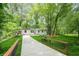 Charming home surrounded by lush greenery with a neatly maintained lawn and scenic drive at 3160 Ann Se Rd, Smyrna, GA 30080