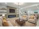 Open-concept living room with a fireplace, built-in shelves, and seamless flow to the dining area and kitchen at 3160 Ann Se Rd, Smyrna, GA 30080