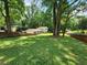 Expansive backyard with a well-maintained lawn and mature trees, ideal for outdoor gatherings and relaxation at 4798 Mary Dale Ct, Lilburn, GA 30047