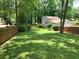 Private backyard oasis with lush greenery and a charming fence, perfect for enjoying nature and outdoor activities at 4798 Mary Dale Ct, Lilburn, GA 30047