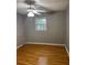 Simple bedroom with hardwood floors and a window providing natural light at 4798 Mary Dale Ct, Lilburn, GA 30047