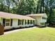 Well-maintained home featuring classic architecture, complemented by vibrant landscaping and a welcoming walkway at 4798 Mary Dale Ct, Lilburn, GA 30047