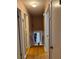Bright hallway with hardwood floors leading to different areas of the home at 4798 Mary Dale Ct, Lilburn, GA 30047