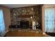 Cozy living room featuring a stone fireplace and hardwood floors, perfect for relaxing at 4798 Mary Dale Ct, Lilburn, GA 30047