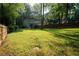 A view of a backyard with a wooden deck, a privacy fence, and mature trees at 4798 Marydale Sw Ct, Lilburn, GA 30047