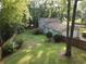 A view of a backyard with a two-car garage and a wooden deck at 4798 Marydale Sw Ct, Lilburn, GA 30047