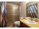 Bathroom featuring a walk-in shower with glass doors and a single vanity at 4798 Marydale Sw Ct, Lilburn, GA 30047