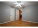 This bedroom offers a ceiling fan, grey walls, and gleaming hardwood floors at 4798 Marydale Sw Ct, Lilburn, GA 30047