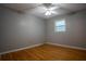 This bedroom features hardwood floors, neutral paint and natural light from the window at 4798 Marydale Sw Ct, Lilburn, GA 30047