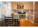 Cozy dining area with wood floors and an open view to the living room with stone fireplace at 4798 Marydale Sw Ct, Lilburn, GA 30047