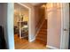 Charming hallway with hardwood floors leading to a staircase and a view of another room at 4798 Marydale Sw Ct, Lilburn, GA 30047