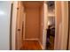 Clean hallway with hardwood floors, and views into the adjacent rooms at 4798 Marydale Sw Ct, Lilburn, GA 30047