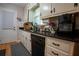 Practical kitchen features a black countertop, dishwasher, and ample cabinet space at 4798 Marydale Sw Ct, Lilburn, GA 30047