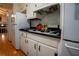 Kitchen features black countertops and ample white cabinet space for storage at 4798 Marydale Sw Ct, Lilburn, GA 30047