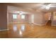 Large, open-concept living room featuring hardwood floors, multiple ceiling fans, and neutral walls at 4798 Marydale Sw Ct, Lilburn, GA 30047