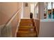 Carpeted staircase with white banister leading to the upper level of the home at 4798 Marydale Sw Ct, Lilburn, GA 30047