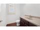 Bathroom featuring a dark wood cabinet, granite countertop, and modern fixtures at 238 Avery Ne St, Marietta, GA 30060