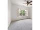 Bright carpeted bedroom with large window and white shutters at 238 Avery Ne St, Marietta, GA 30060
