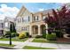 Charming two-story home with stone accents, a covered front porch, and mature landscaping at 238 Avery Ne St, Marietta, GA 30060