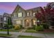Charming two-story home boasts a stone and siding exterior with a welcoming front porch and landscaped yard at 238 Avery Ne St, Marietta, GA 30060