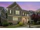 Charming two-story home boasts a stone and siding exterior with a welcoming front porch and landscaped yard at 238 Avery Ne St, Marietta, GA 30060