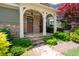 Inviting front porch with stone accents, arched entryway, and beautifully landscaped surroundings at 238 Avery Ne St, Marietta, GA 30060