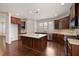 Spacious kitchen with a large island, stainless appliances, dark wood cabinets, and hardwood floors at 238 Avery Ne St, Marietta, GA 30060