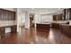 Open kitchen with dark wood cabinets, large island, stainless steel appliances, and hardwood floors at 238 Avery Ne St, Marietta, GA 30060