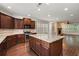 A kitchen featuring stainless steel appliances, a center island, and dark wood cabinets at 238 Avery Ne St, Marietta, GA 30060