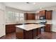 Well-equipped kitchen features dark wood cabinets, granite countertops, and stainless steel appliances at 238 Avery Ne St, Marietta, GA 30060