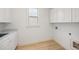 Laundry room with white cabinets, utility sink, and light colored flooring at 238 Avery Ne St, Marietta, GA 30060