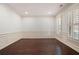Bright living room featuring hardwood floors, wainscoting, and large windows with shutter blinds at 238 Avery Ne St, Marietta, GA 30060