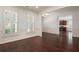 Open living room with hardwood floors, wainscoting, and views of the kitchen and large shuttered windows at 238 Avery Ne St, Marietta, GA 30060