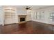 Living room with hardwood floors, built-in shelving, stone fireplace, and lots of natural light at 238 Avery Ne St, Marietta, GA 30060
