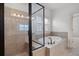 Bathroom featuring a glass enclosed shower and a soaking tub with tile surround at 238 Avery Ne St, Marietta, GA 30060