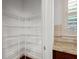 Walk-in pantry with white wire shelving and countertops adjacent to a window at 238 Avery Ne St, Marietta, GA 30060